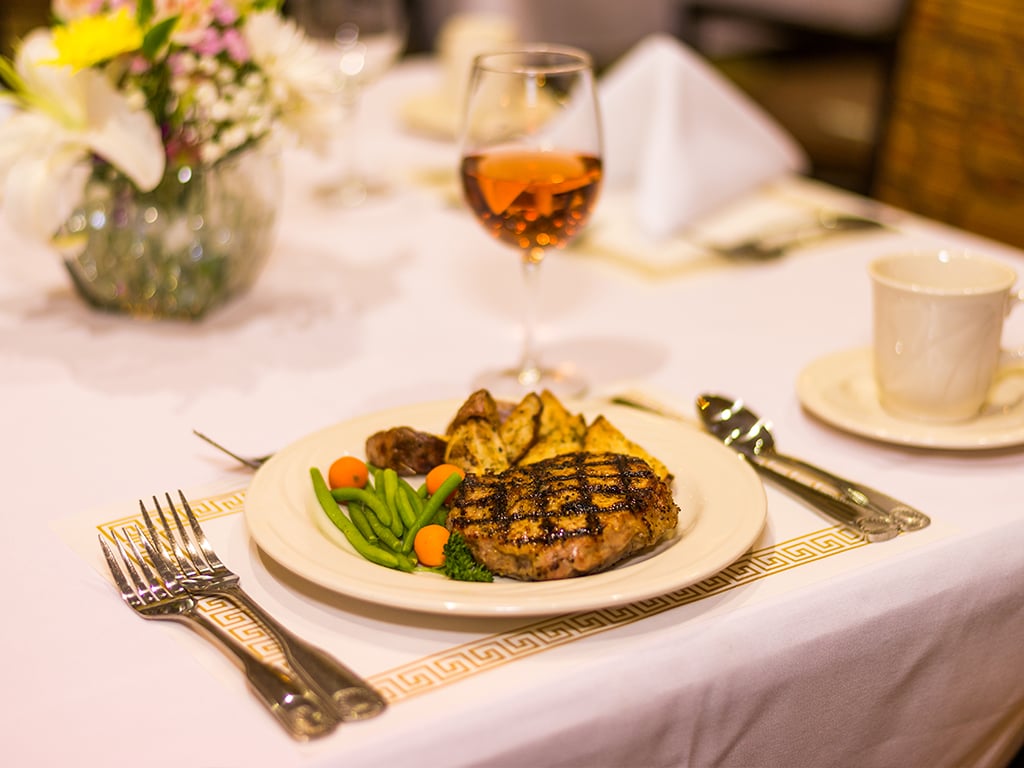 plate of grilled salmon and potatoes at our dining venues